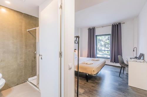 a bedroom with a bed and a desk in a room at HI Lisboa Oriente - Pousada de Juventude in Lisbon