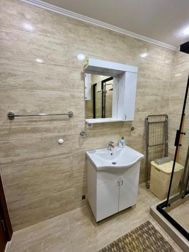 a bathroom with a sink and a mirror at Juliya Apartment in Kavadarci