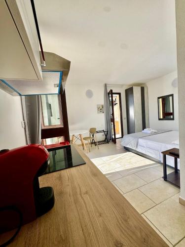 a bedroom with a bed and a glass table at Elyas Guest House in Villasimius