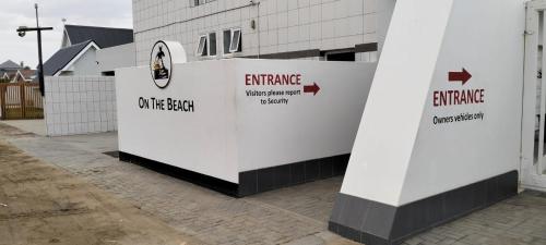 a white building with arrows on the side of it at On the Beach 20 in Swakopmund
