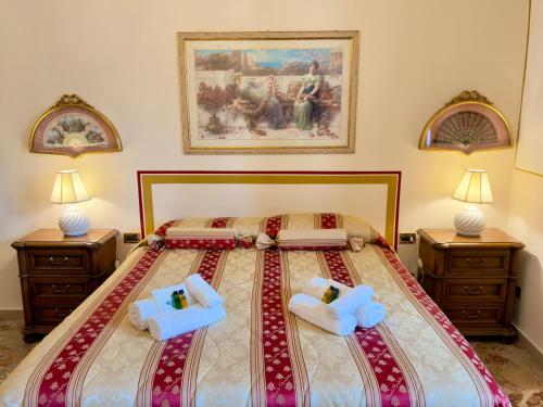 a bedroom with a large bed with two night stands at Suite Apartment Mandorlo in Volterra