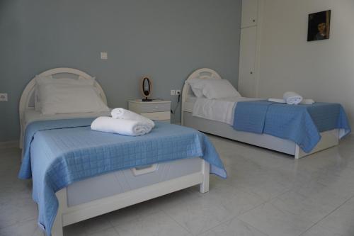 two beds in a hospital room with towels on them at El Condor Casa in Rhodes Town