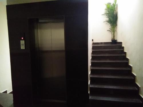 a stairway with a door and a potted plant at grand empark in Bangalore
