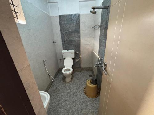 a bathroom with a toilet and a sink at grand empark in Bangalore