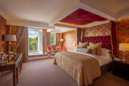 a bedroom with a large bed and a large window at Hotel Kilmore in Cavan