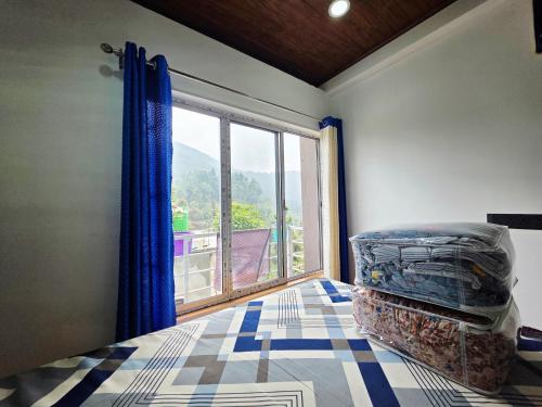 a bedroom with a window and a bed with a view at Neoravalley Homestay, Lava in Rishop
