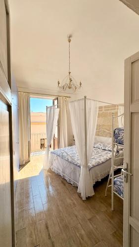 a bedroom with a bed and a view of the desert at Al centro con panorama Favignana Isole Egadi in Favignana