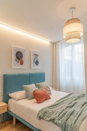 a bedroom with a bed with a blue headboard at Lumen Mare Malvarrosa by SH Hoteles in Valencia