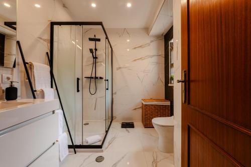 a bathroom with a shower and a toilet at Caldas Charm Getaway - Garden Terrace & Comfort in Caldas da Rainha