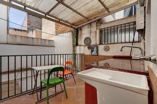 a kitchen with a sink and a table and chairs at Casacuéntame in Granada