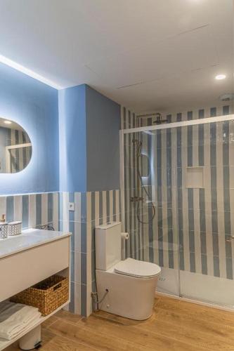 a bathroom with a toilet and a sink and a shower at Lumen Mare Malvarrosa by SH Hoteles in Valencia