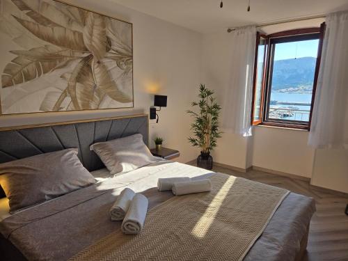a bedroom with a bed with two towels on it at Apartment Borna in Baška