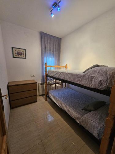 a bedroom with two bunk beds and a window at MEDDAYS Villa BERLÍN in Miami Platja