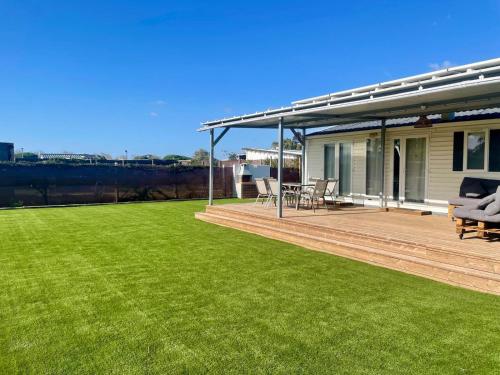 a house with a large yard with green grass at El Palmar Paradise in El Palmar