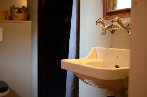 a bathroom with a sink and a mirror at Gasthaus Rössli in Trogen