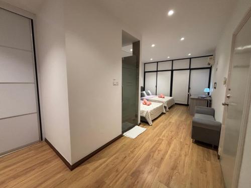 a living room with a couch and a bed and a mirror at Roxy Apartment Kuching in Kuching