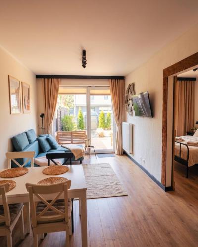 a living room with a couch and a table at Sea & Home in Gąski