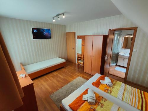 a small room with a bed and a bathroom at Sárga Apartman Ház in Balatonfüred