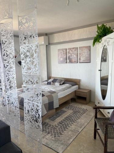 a bedroom with a bed and a mirror at Villa Noza Kalamos in Kalamos