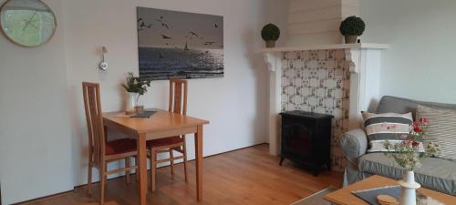 a living room with a table and a couch at Torenlicht - Zand I (36) in Egmond aan Zee
