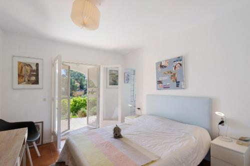 a bedroom with a bed with a cat sitting on it at Puigvermell in Pals
