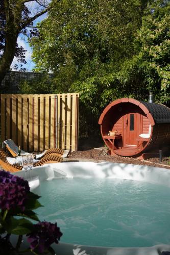 a swimming pool with a dog house next to a fence at Natuurhuisje Laanzicht Ophemert in Ophemert