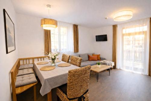 a living room with a table and a couch at Apartmány Lipno-Hory in Horní Planá