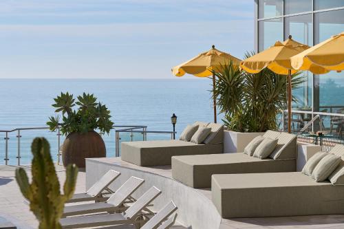 a patio with couches and chairs and the ocean at Hotel Riviera Costa del Sol - Adults Recommended in Benalmádena