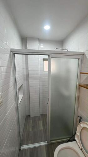 a bathroom with a shower and a toilet at Berchby Loft in Digos