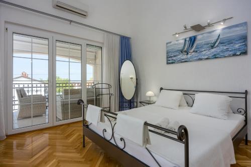 a bedroom with a bed and a balcony at Apartments Covic in Antonci