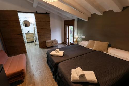 a bedroom with a large bed with towels on it at Hostal Rural Sartaguda in Sartaguda