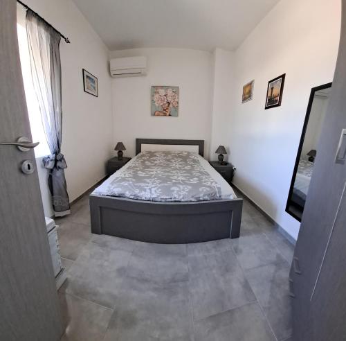 a bedroom with a bed in the middle of a room at Despina in Kritinía