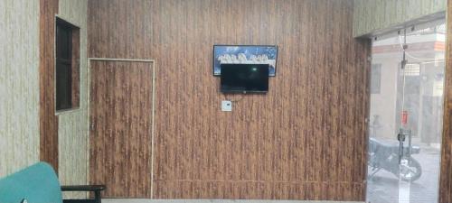 a room with a door with a television on a wall at Hotel Paradise in Chandīgarh
