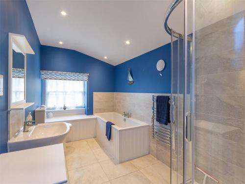a bathroom with a tub and a sink and a shower at 6 Bed in Strathcarron oc-ca343 in Applecross