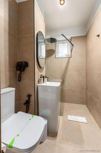 a bathroom with a toilet and a sink and a mirror at Apartament Nordic 3 in Gura Humorului