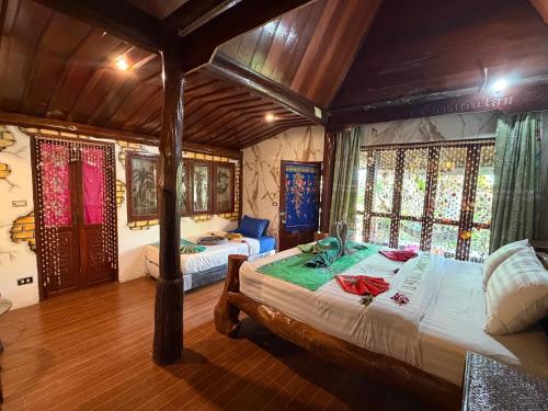 a bedroom with two beds in a room at P P Garden Home Bungalow in Phi Phi Islands
