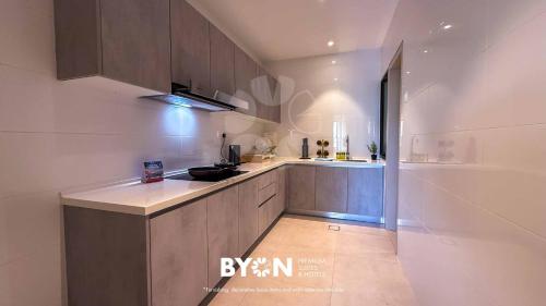 a kitchen with a sink and a counter top at Enclave Nature Suites Bukit Tinggi by BYON in Bentong