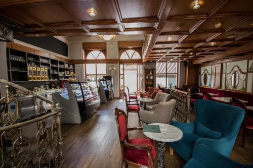 a bar with chairs and tables in a room at Hotel Ovo malo duše in Sarajevo