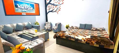 a living room with a bed and a couch at ayodhya homestay in Faizābād
