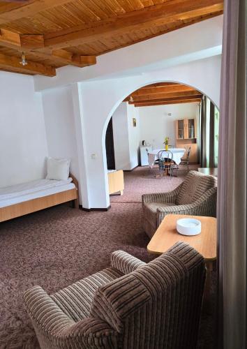 a living room with two couches and a table at Vila Pufu in Slănic-Moldova