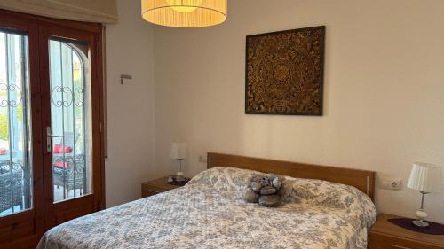 a teddy bear sitting on a bed in a bedroom at MEDDAYS Villa CARMEN in Miami Platja