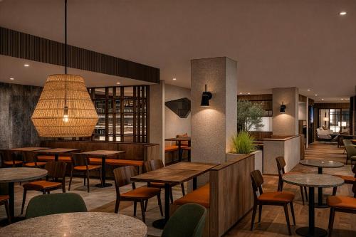 a restaurant with tables and chairs and a lobby at Hotel Himàlaia Soldeu by Nexta in Soldeu