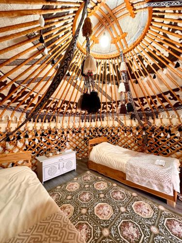 a room with two beds in a yurt at Kilemche Boutique Hotel & Yurt Camp in Bagysh