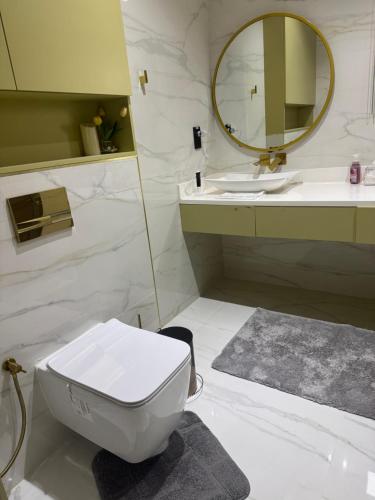 a bathroom with a toilet and a sink and a mirror at Mount Hut in Dubai