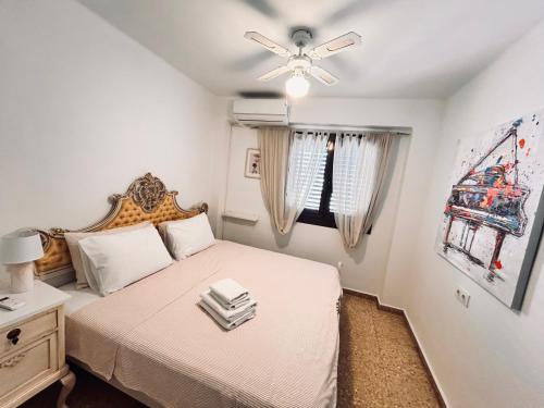 a bedroom with a bed and a ceiling fan at On the Beach Oliva in Oliva