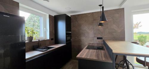 a kitchen with a black refrigerator and a counter at Quinta Cuadrao in Cartavio