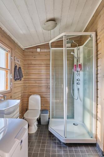 a bathroom with a shower and a toilet at Holiday Cabin Kukkula - AC, fireplace & wood-fired sauna in Porvoo