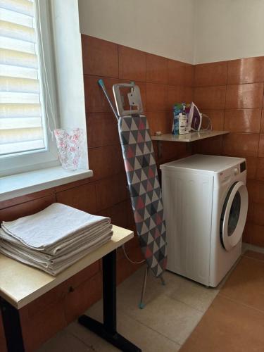 a laundry room with a washing machine next to a window at Vaivari Retreat in Jūrmala