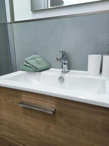 a bathroom sink with a green towel on it at Casa Zia Maria in Pollina