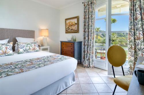 a hotel room with a bed and a window at Hôtel La Grande Bastide - Teritoria in Saint Paul de Vence